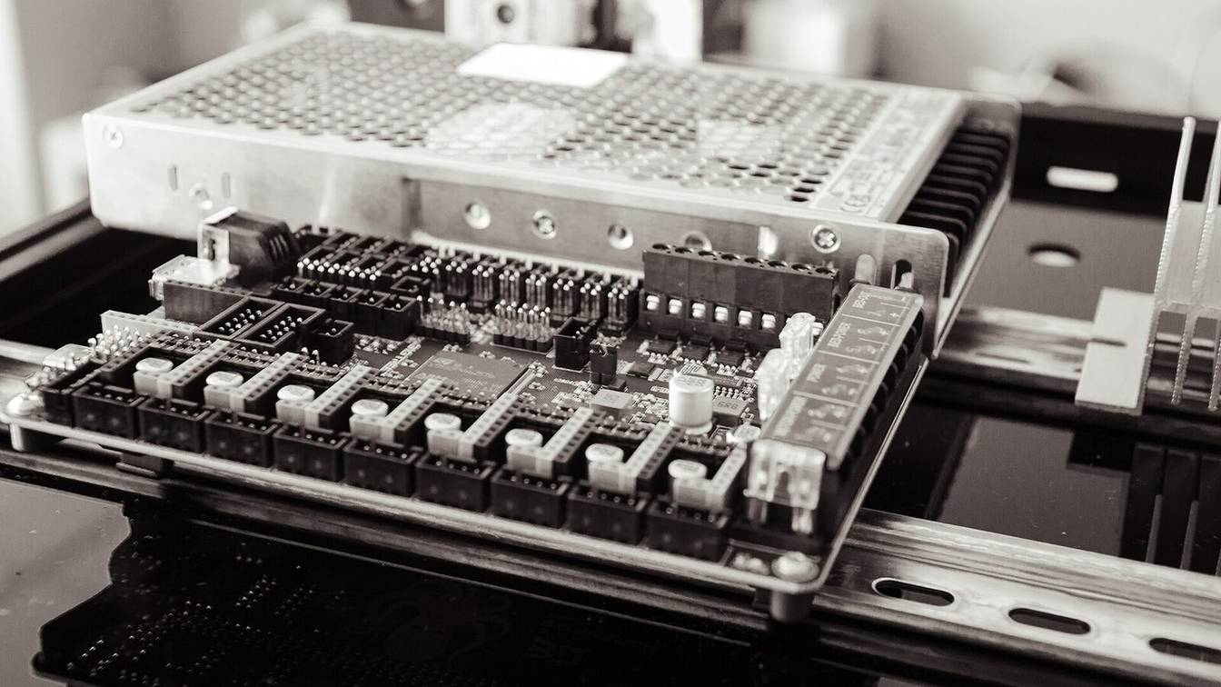 The electronics bay of a Voron 3D printer, with the controller board and power supply on a DIN rail