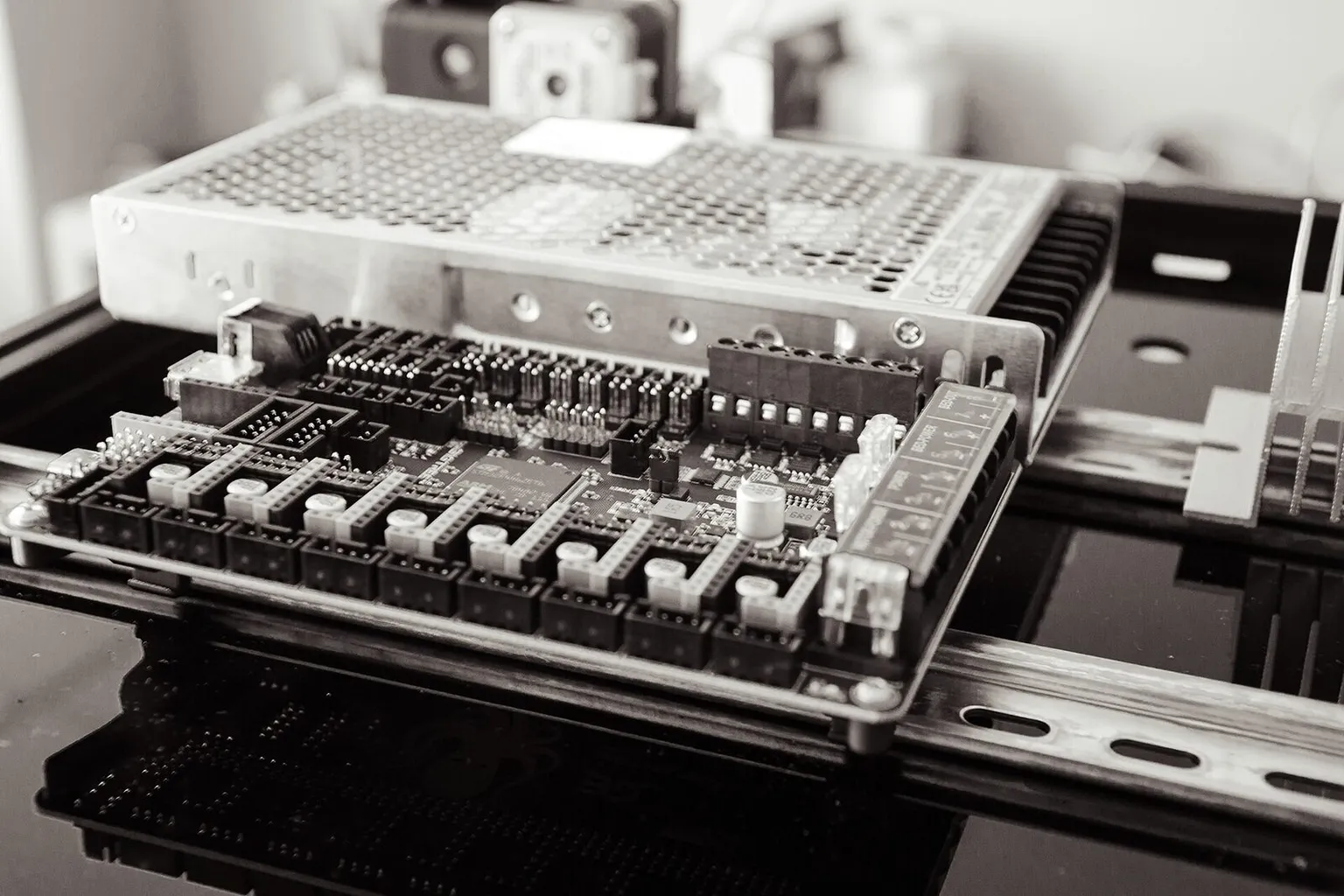 The electronics bay of a Voron 3D printer, with the controller board and power supply on a DIN rail