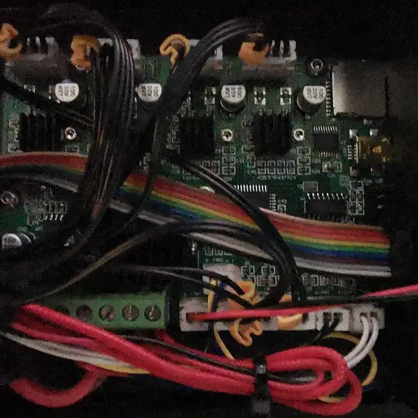 The opened electronics case of a Creality Ender 3, showing the mainboard and its wiring