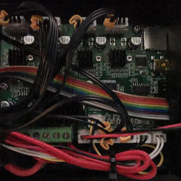 The opened electronics case of a Creality Ender 3, showing the mainboard and its wiring