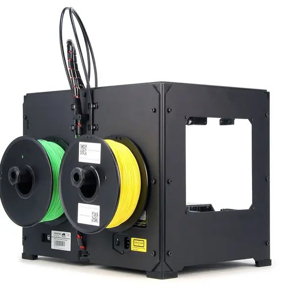 A black steel-framed desktop 3D printer seen from the back, with a green and a yellow filament spool mounted side by side and two feed tubes running over the top