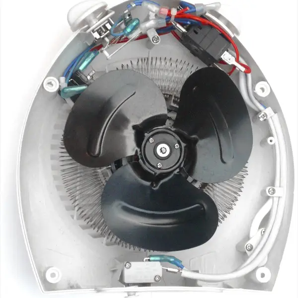 The inside of an opened electric fan heater: a black three-blade fan in front of a coiled heating element, crimped wiring and switches along the top, and the power cable held by clamps down one side