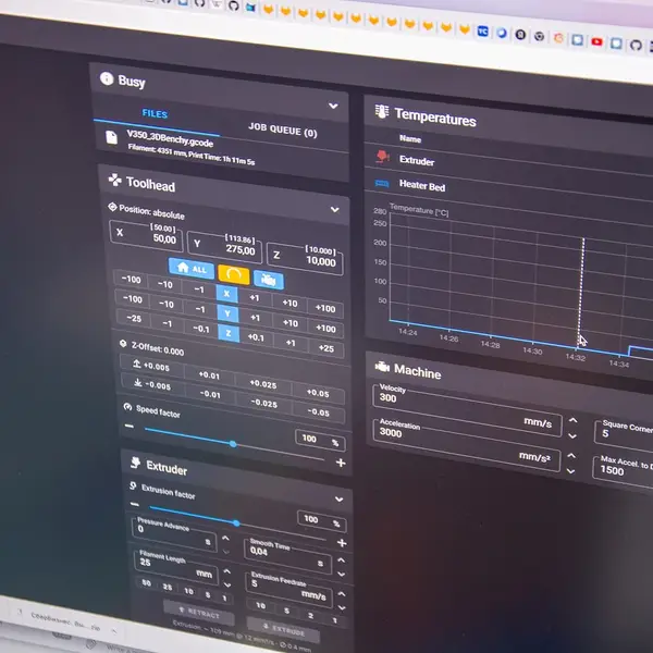 A Klipper web interface on a screen, showing toolhead position and a temperature graph
