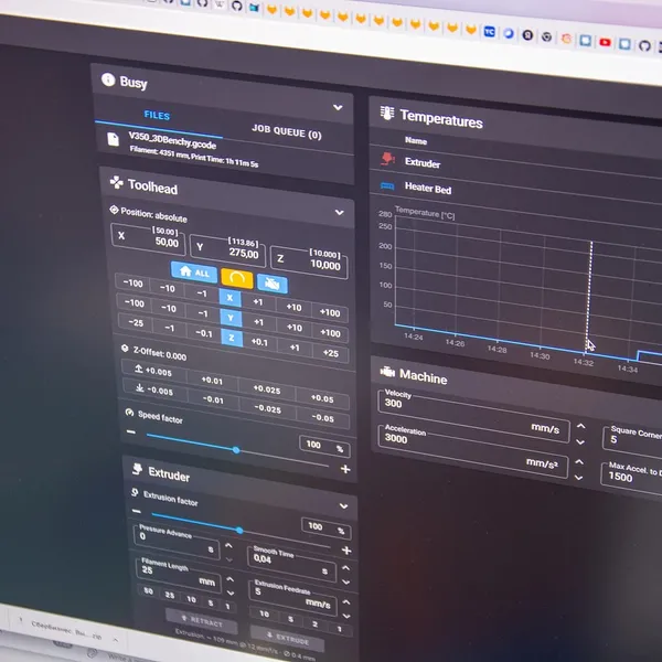 A Klipper web interface on a screen, showing toolhead position and a temperature graph