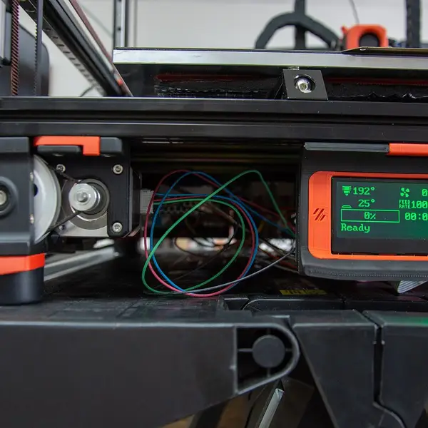 The front of a Voron printer with a small LCD status display and control knob