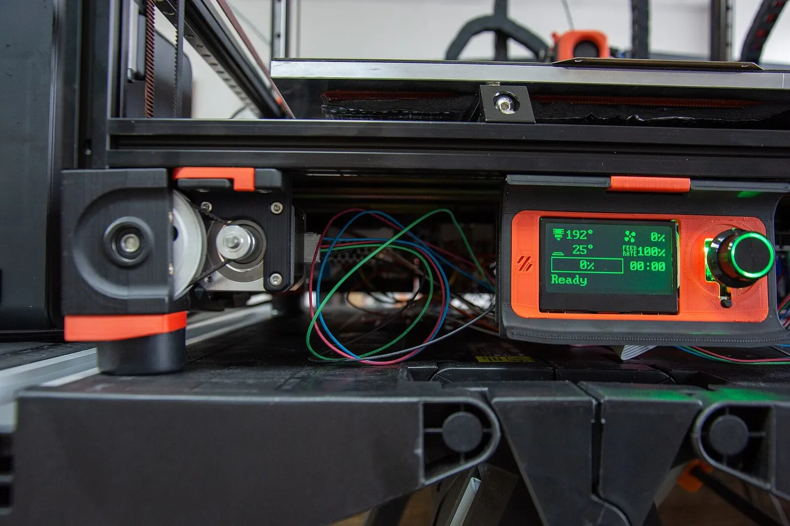 The front of a Voron printer with a small LCD status display and control knob
