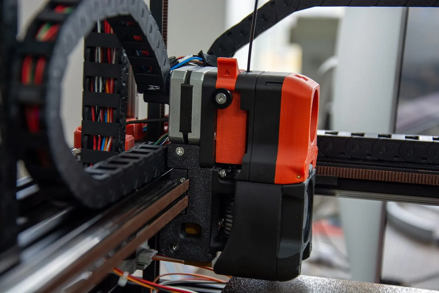 A Voron toolhead seen from the side, showing its extruder, wiring and cable chain