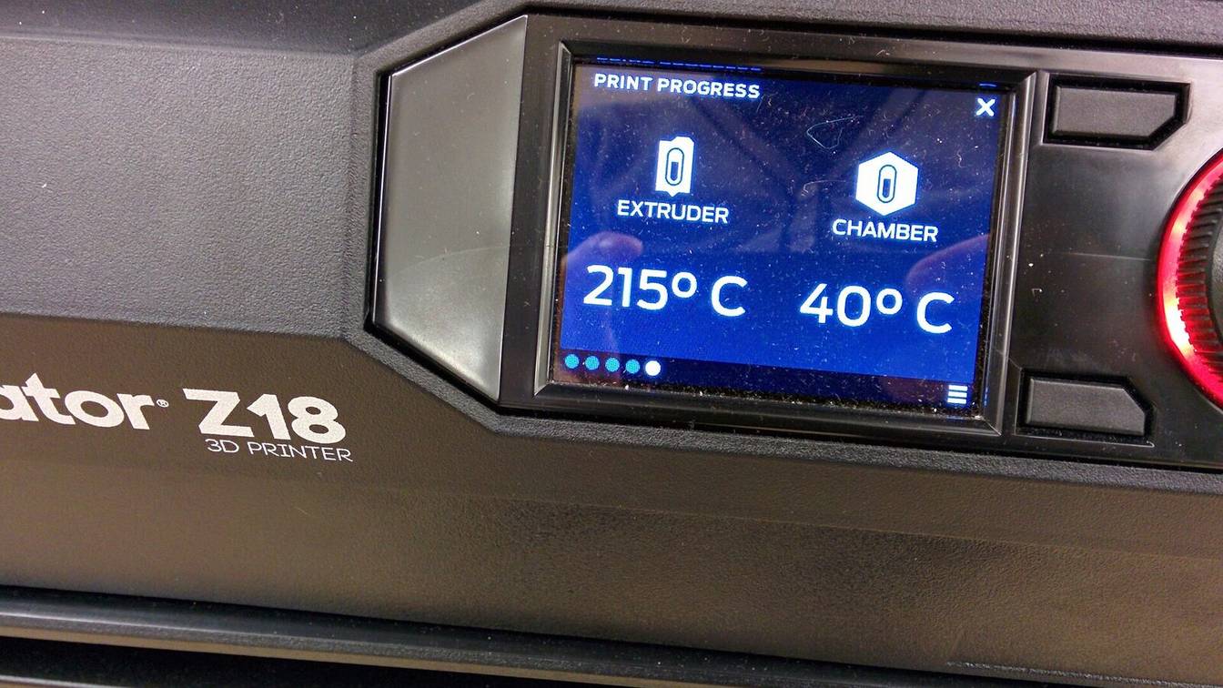 A printer touchscreen showing the extruder at 215 °C and the chamber at 40 °C