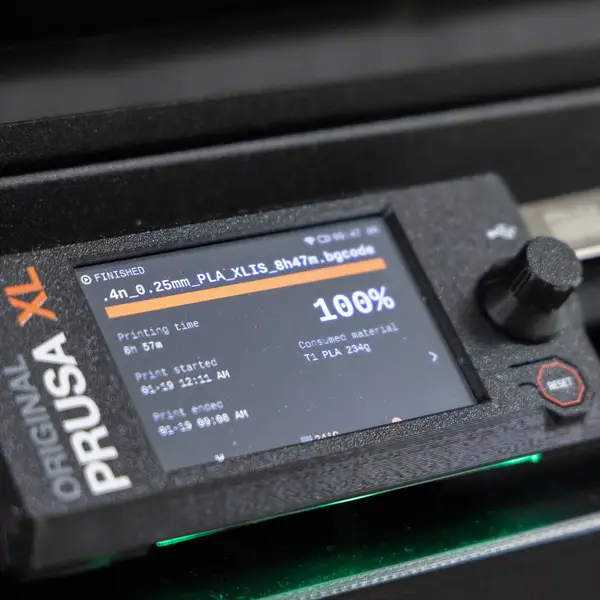 The control panel of an Original Prusa XL: a screen showing a finished 8 h 57 min PLA print using 234 g from tool T1, a control knob, a reset button and a USB drive