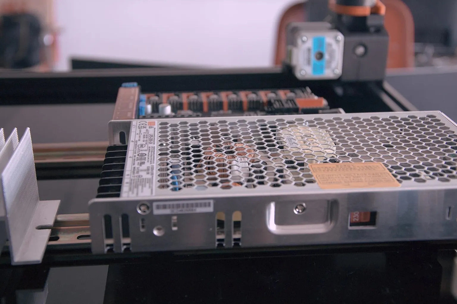 A Mean Well power supply and controller board in the electronics bay of a Voron printer