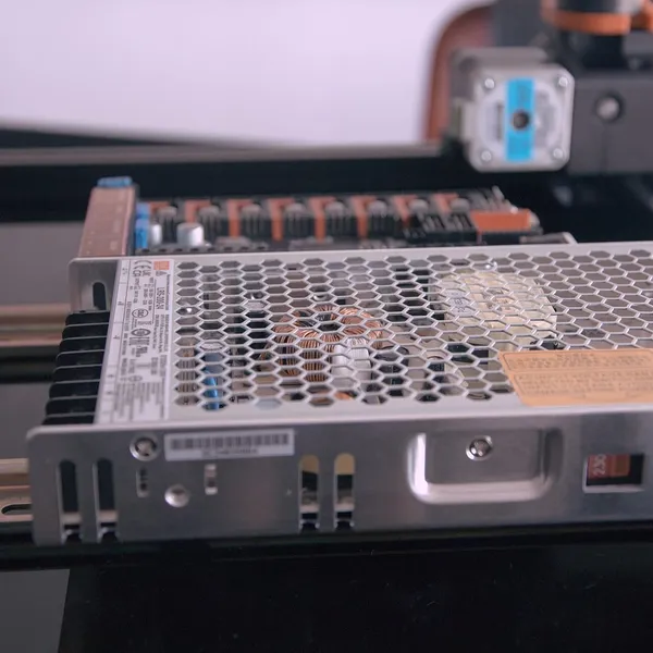 A Mean Well power supply and controller board in the electronics bay of a Voron printer